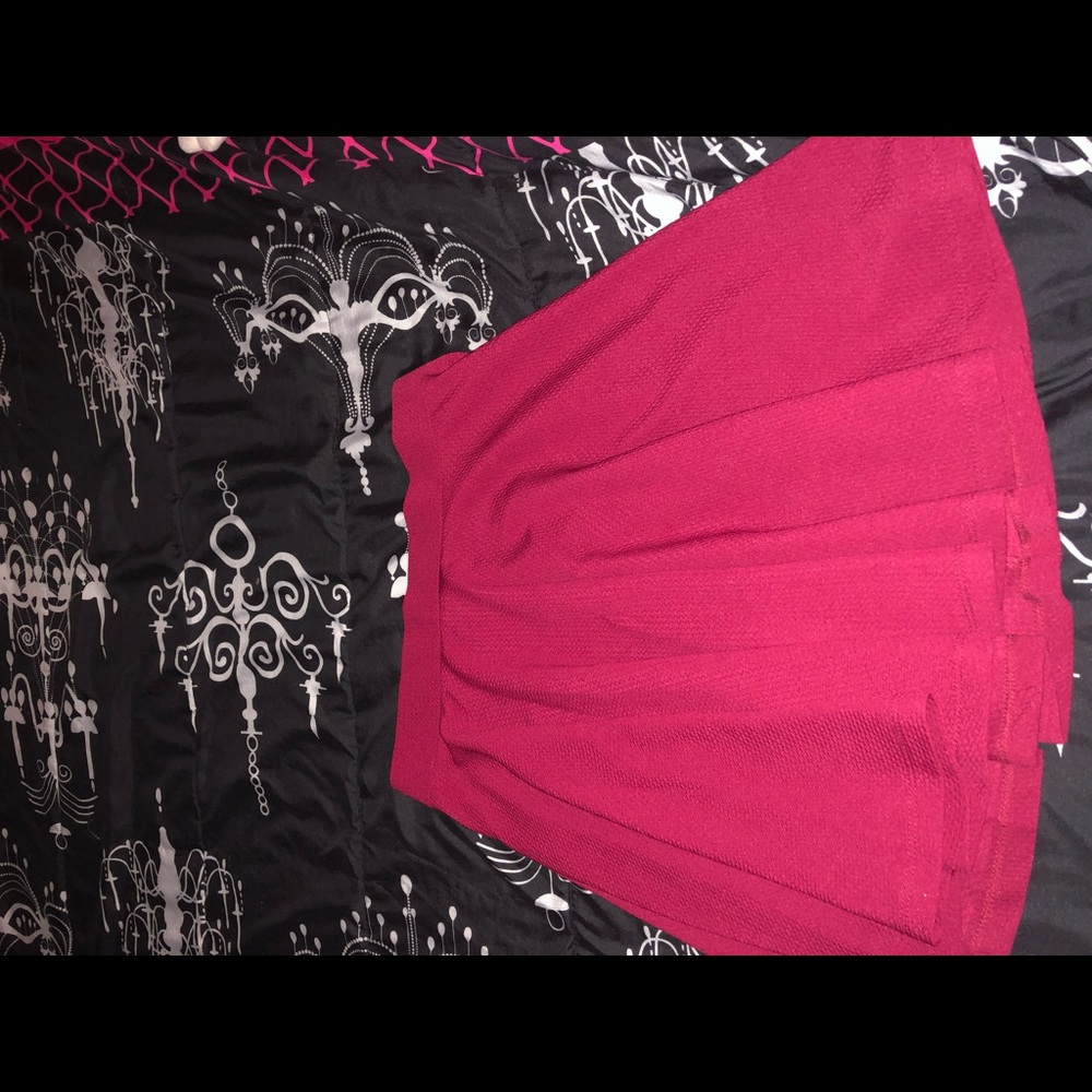 Maroon colored skirt.